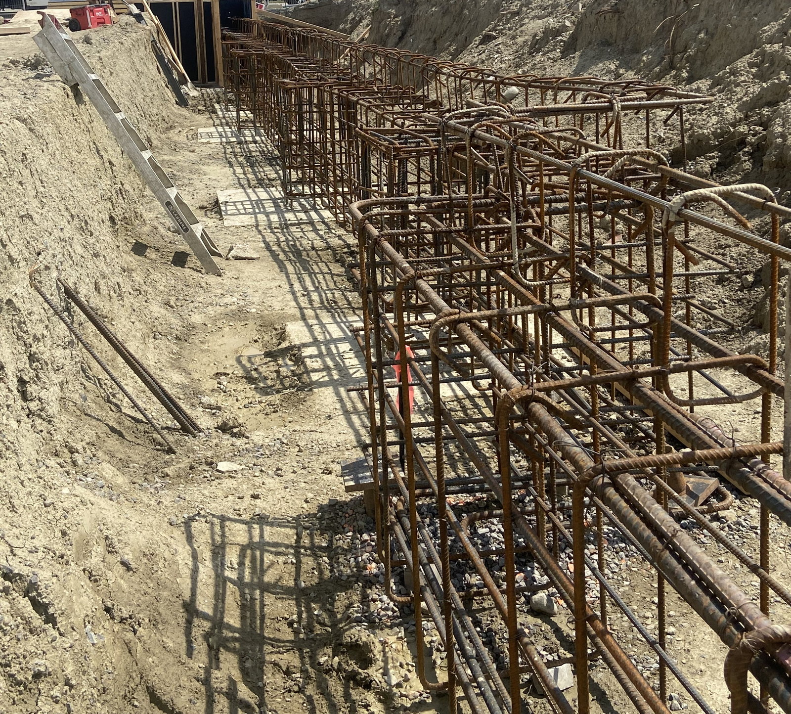 Reinforcing steel extending through a foundation excavation