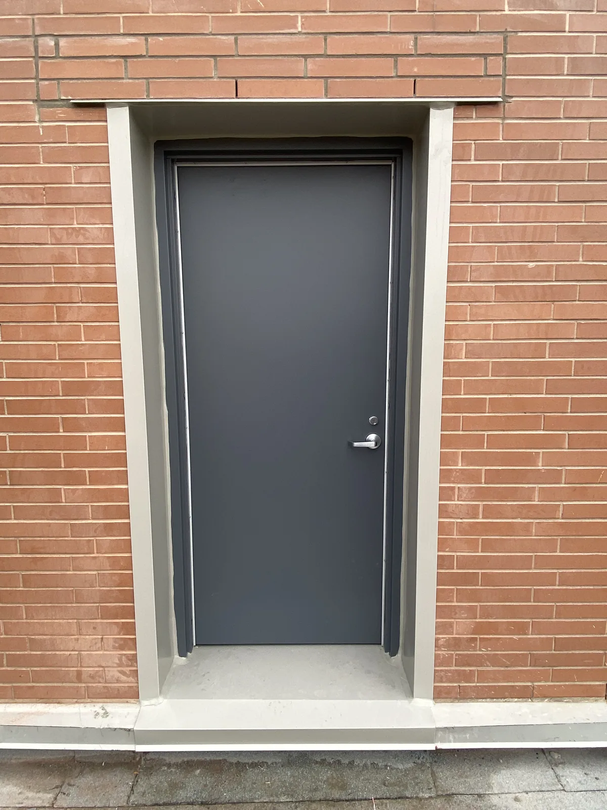 Completed new commercial door opening in an existing masonry wall