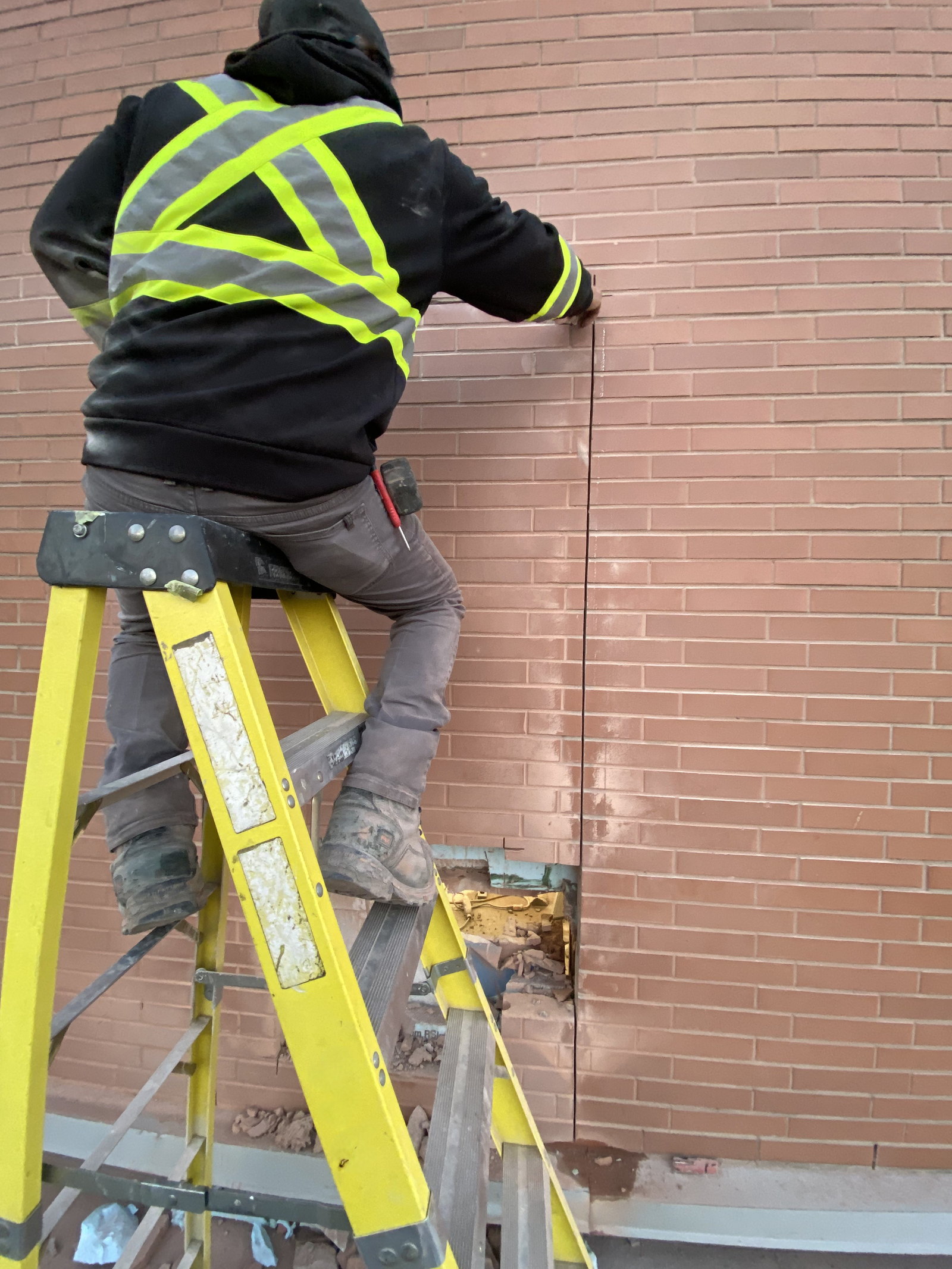 Exterior brick wall during preparation of a new door opening
