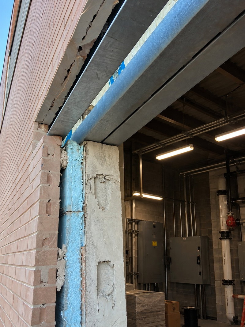 Lintel and head detail above a new commercial door opening