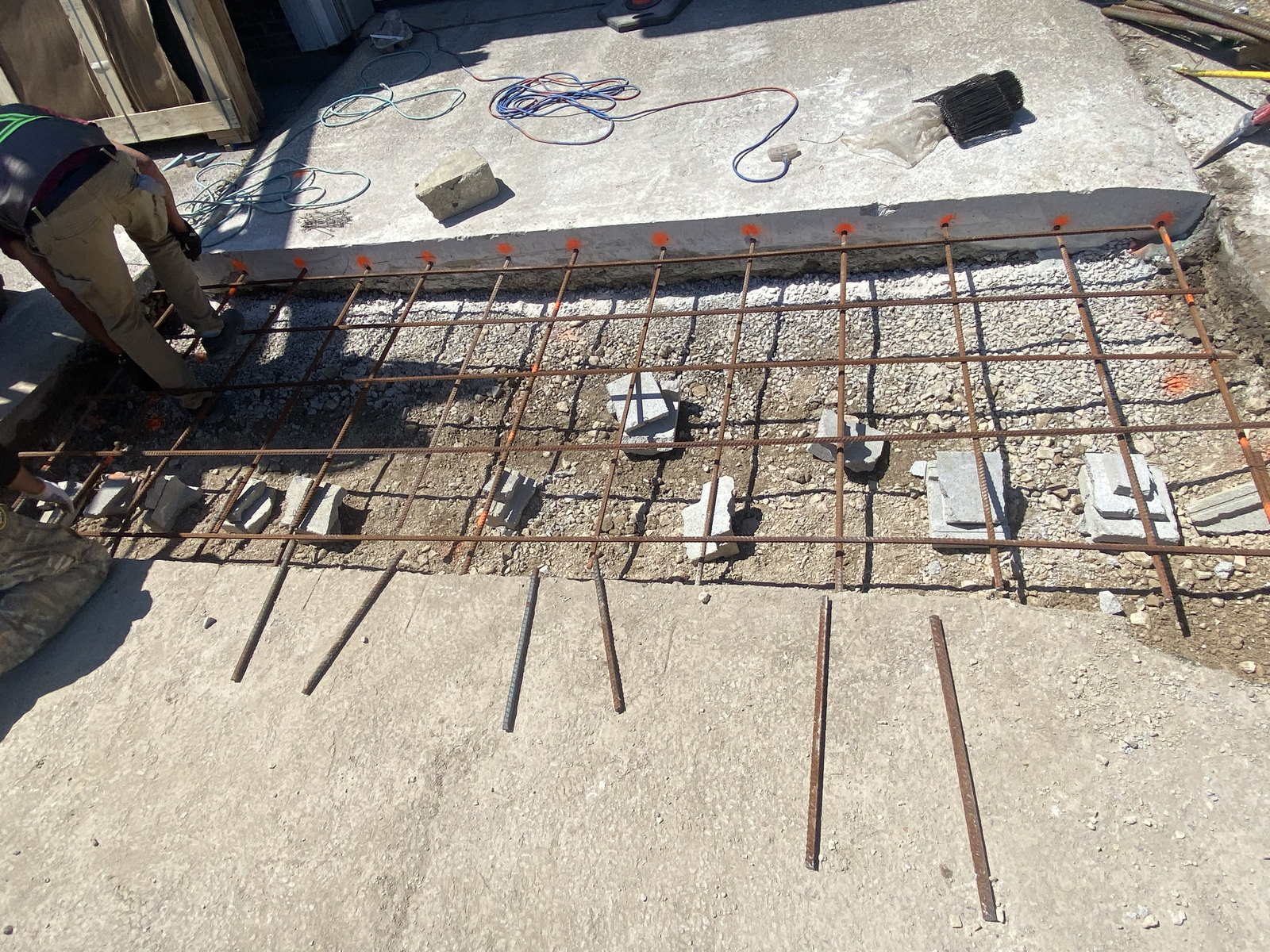 Reinforced concrete apron area prepared at an overhead door