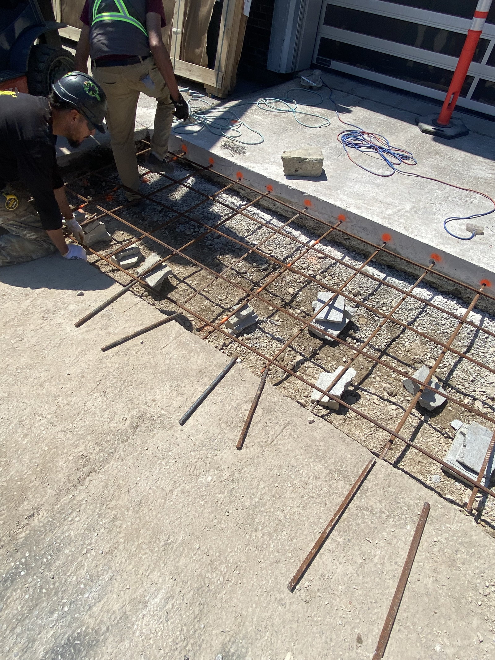 Reinforcing steel and embedded components prepared for a concrete apron