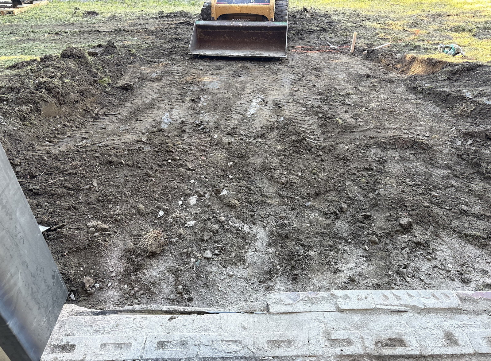 Excavated area in front of a commercial overhead door