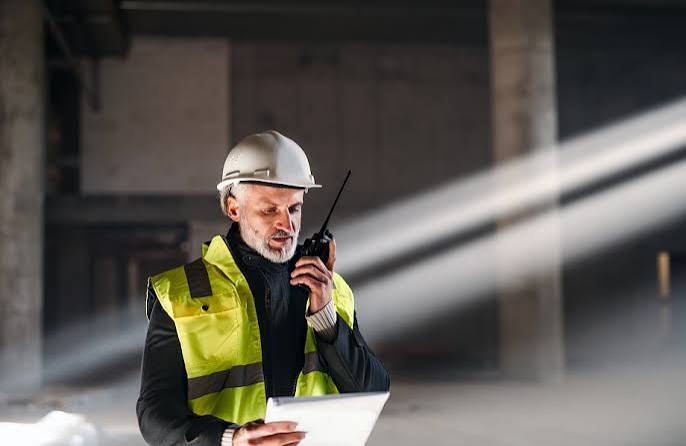 Construction supervisor coordinating work on site